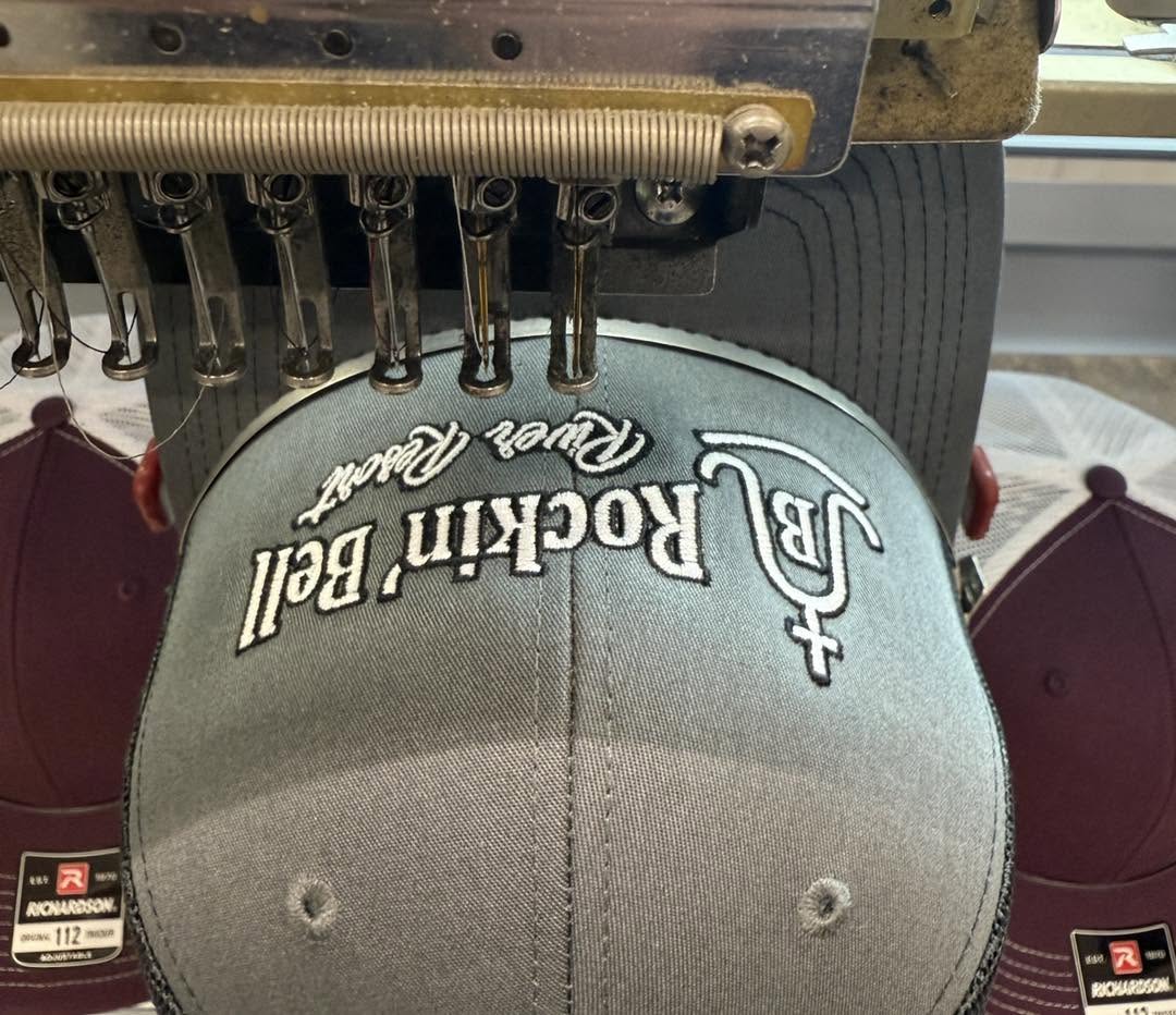 Embroidery machine stitching a custom hat